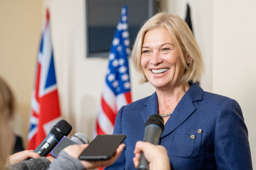 Smiling Female Politician Talking To Press